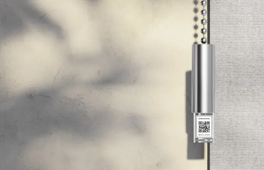 A MotionBlinds tubular motor with its pairing QR code beside a roller blind chain, supplied by Custom Blinds Shutters & Awnings