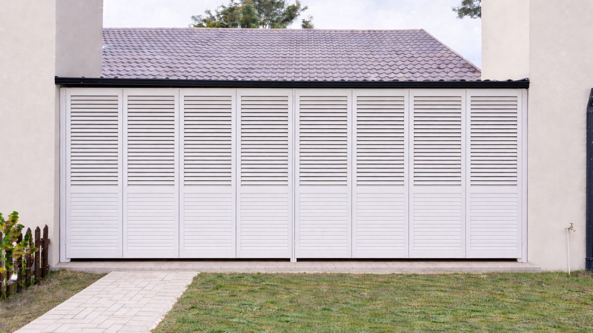 White aluminium security shutters closed across a wide patio opening, Custom Blinds Shutters & Awnings