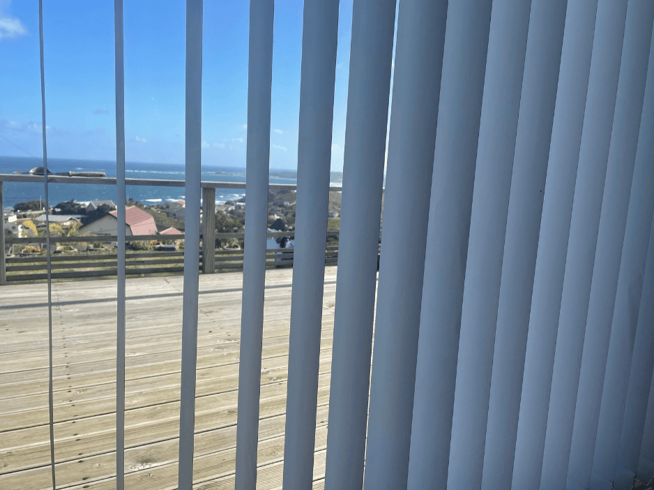 Vertical blinds at a Brenton-on-Sea home letting in sea views and coastal light, installed by Custom Blinds Knysna