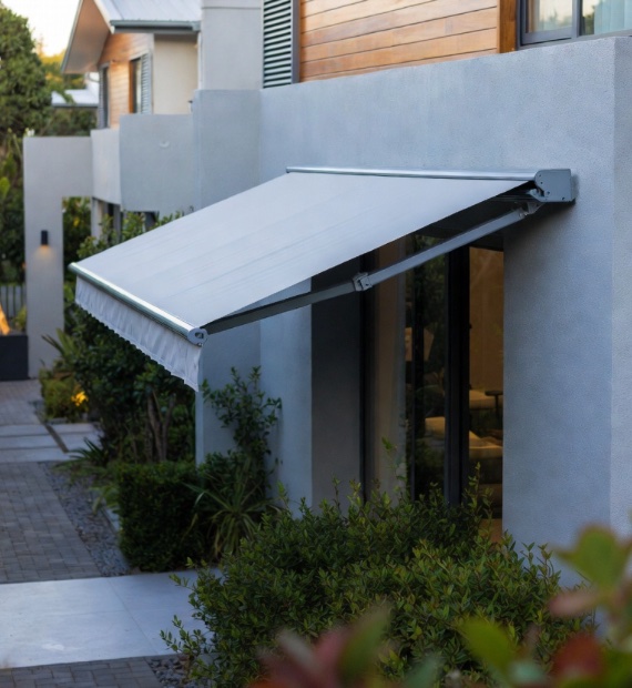 Fall arm awning in grey acrylic canvas on a contemporary home, Custom Blinds Shutters & Awnings