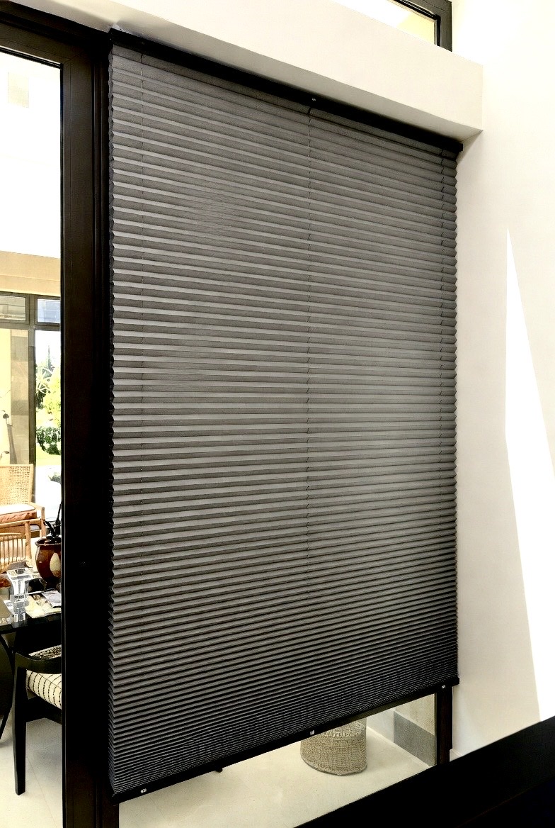 Grey duotone honeycomb blinds on a sliding door in a South African home, light-filtering cellular shades by Custom Blinds