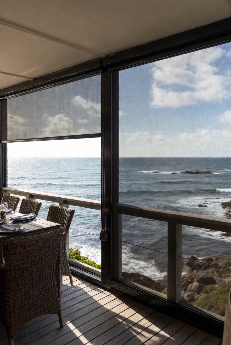 Clear PVC outdoor blinds protecting a Sedgefield dining patio, Custom Blinds Shutters & Awnings