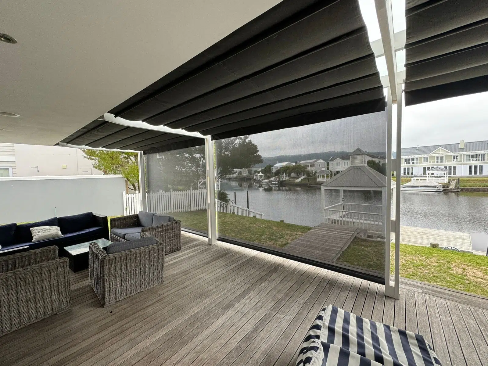 Retractable patio awning with Somfy motorisation on a Thesen Island Knysna deck, installed by Custom Blinds Garden Route