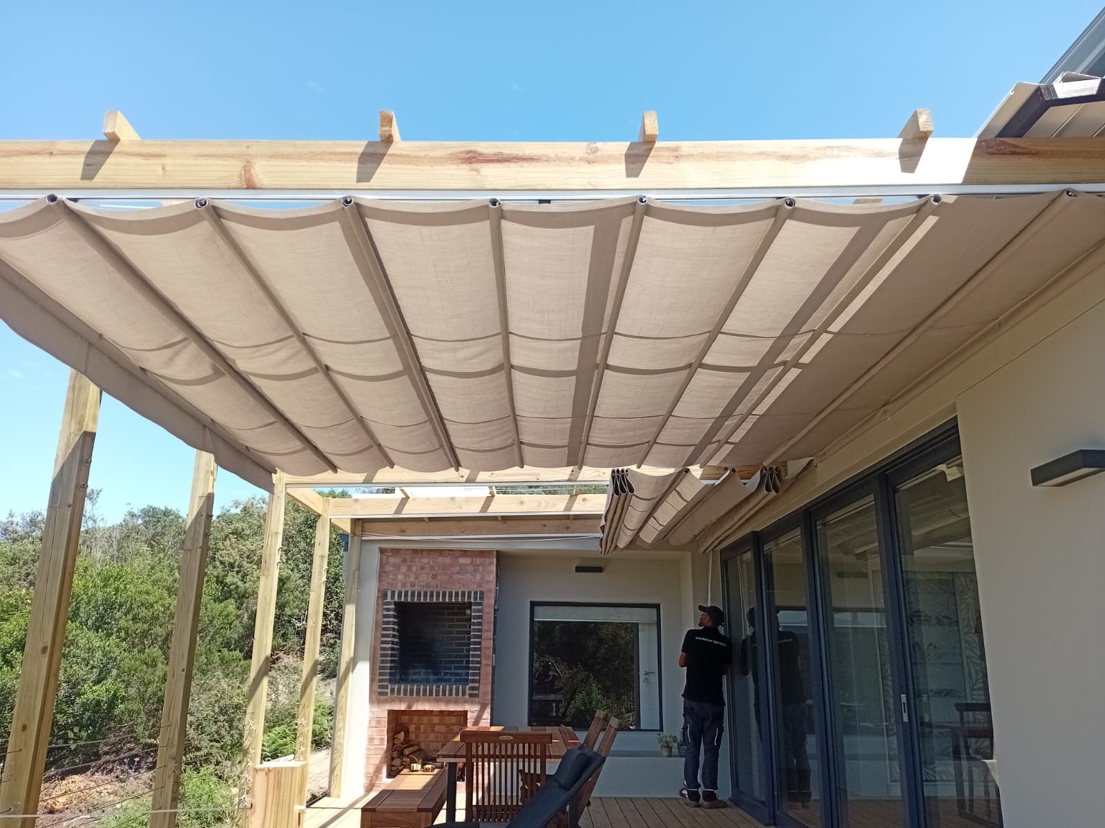 Retractable patio shade awning underside showing fabric panels and timber pergola at Westward Bridge Eco Estate Knysna, Custom Blinds Shutters & Awnings