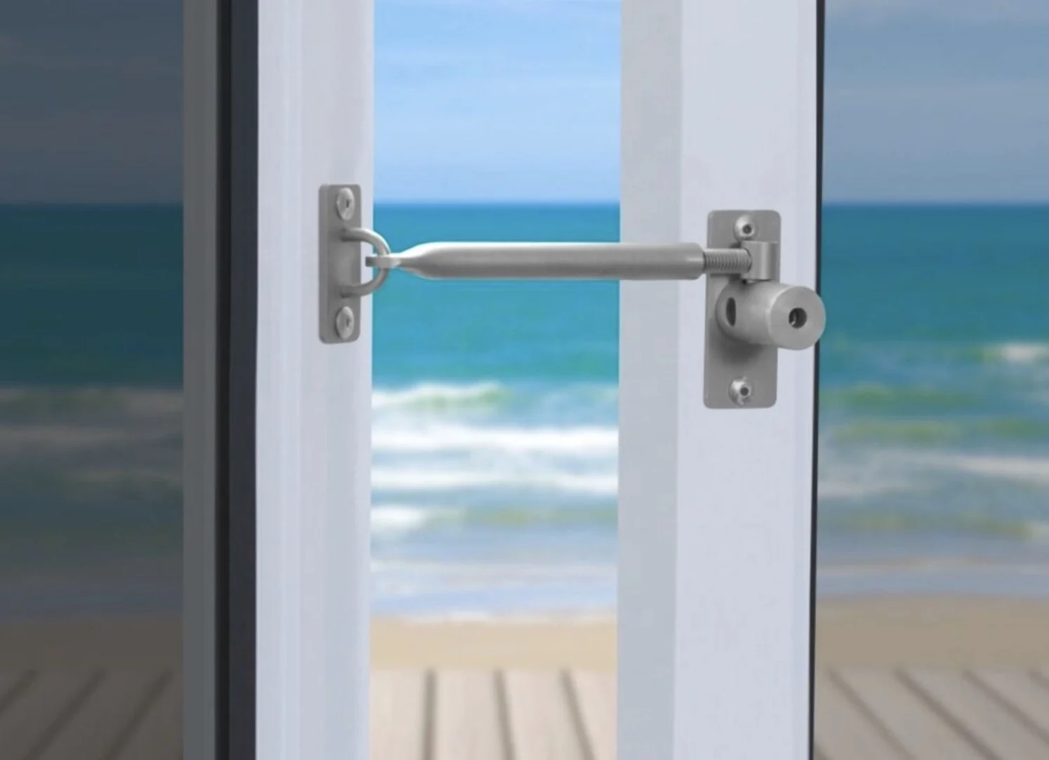 A LockLatch safety latch engaged between a door and its frame, holding the door open a set distance, supplied by Custom Blinds Shutters & Awnings