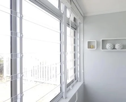 Clear polycarbonate safety bars by Custom Blinds Shutters & Awnings across a bedroom window, the view kept, Garden Route, South Africa