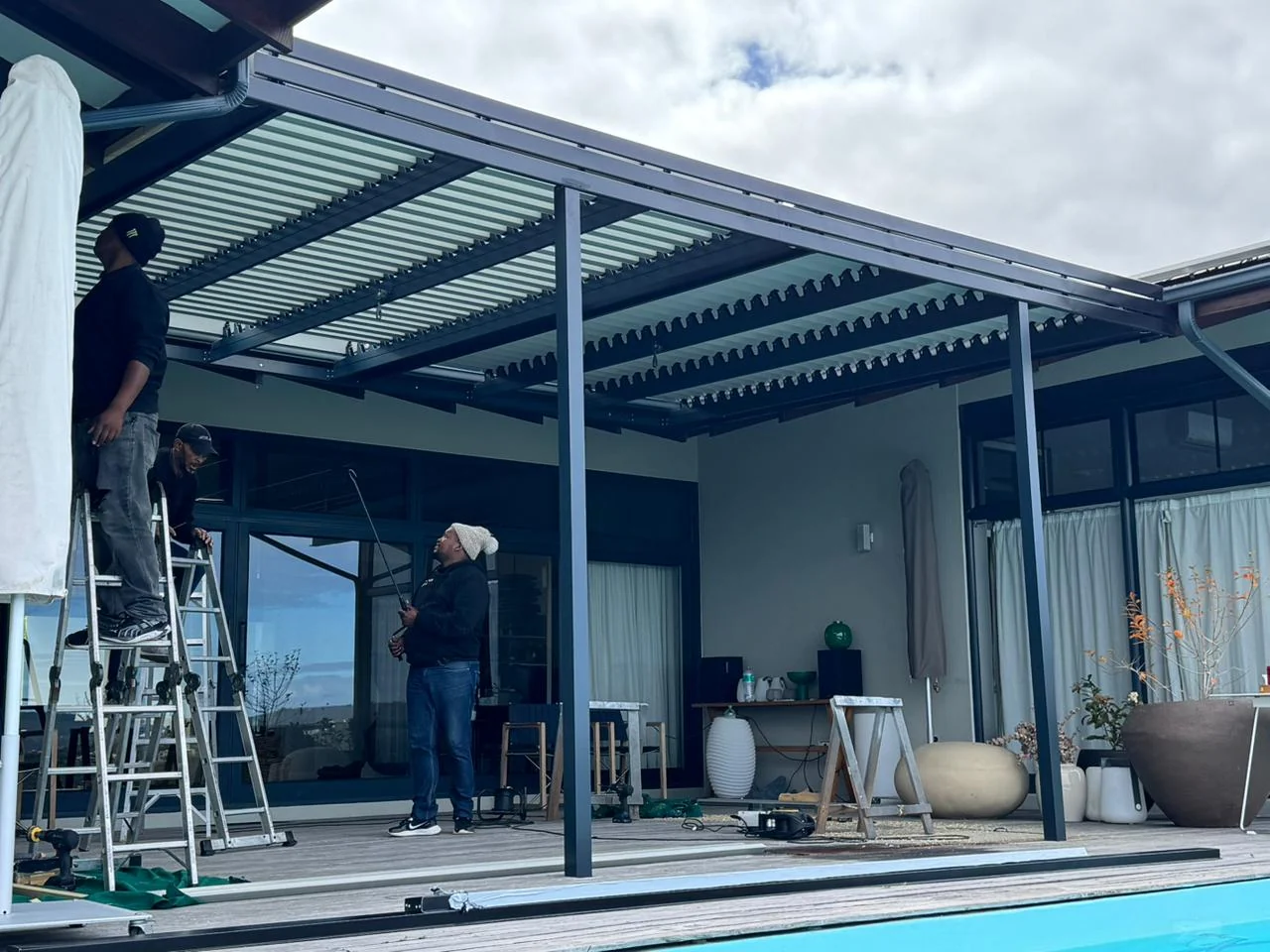 Aluminium louvred awning installation in progress at Simola Estate, Knysna, by Custom Blinds Shutters & Awnings