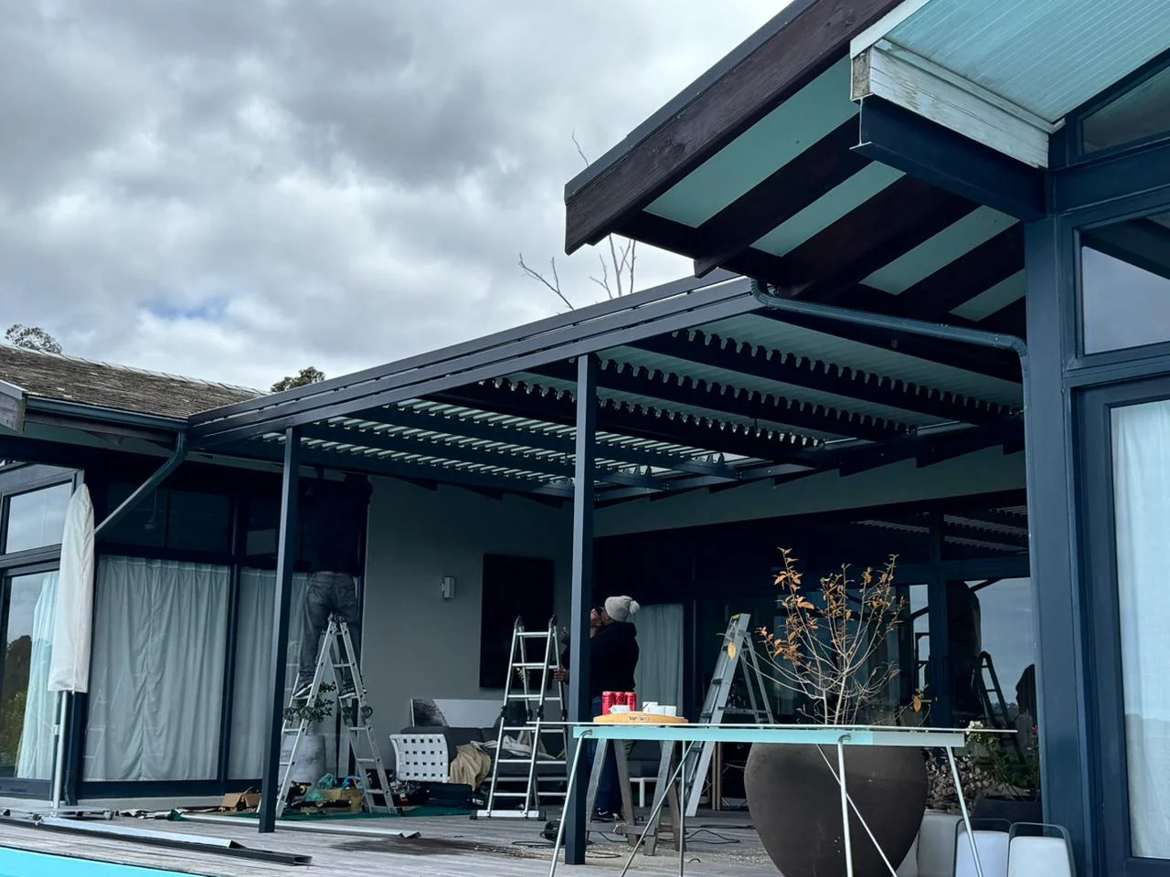 Aluminium louvred awning installation in progress at Simola Estate, Knysna, by Custom Blinds Shutters & Awnings