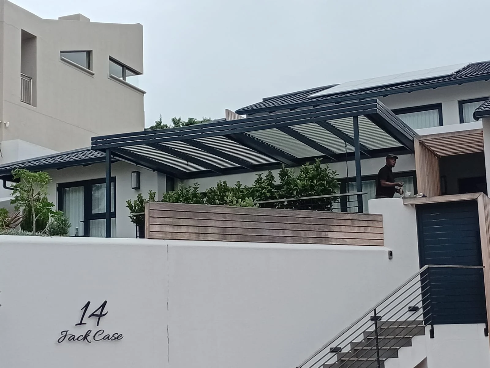 Aluminium louvred awning exterior view over patio at Beachy Head Drive, Plettenberg Bay by Custom Blinds Shutters & Awnings, Plettenberg Bay, Garden Route, South Africa