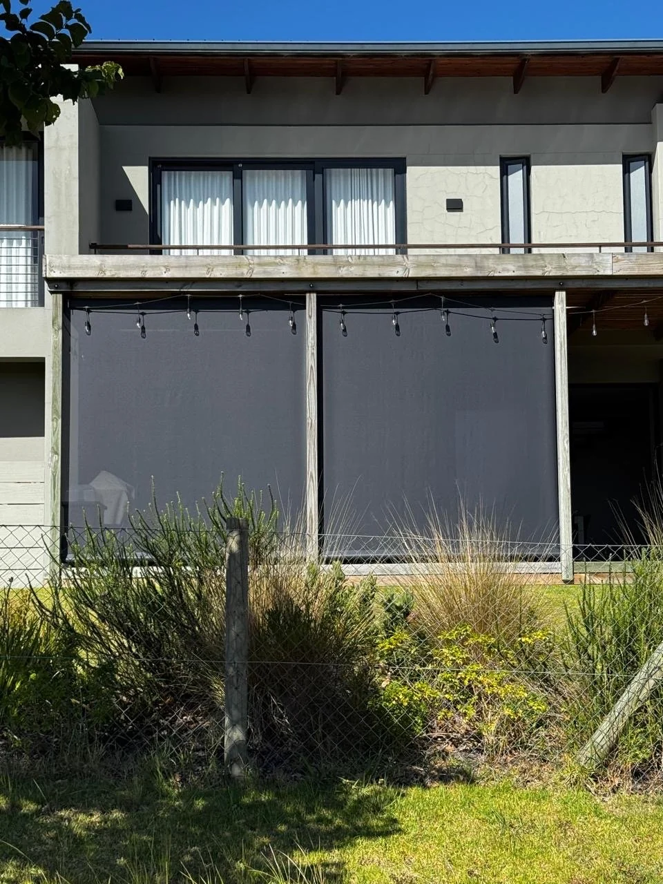 Outdoor blinds Knysna double-bay balcony installation by Custom Blinds Shutters & Awnings, Garden Route, South Africa
