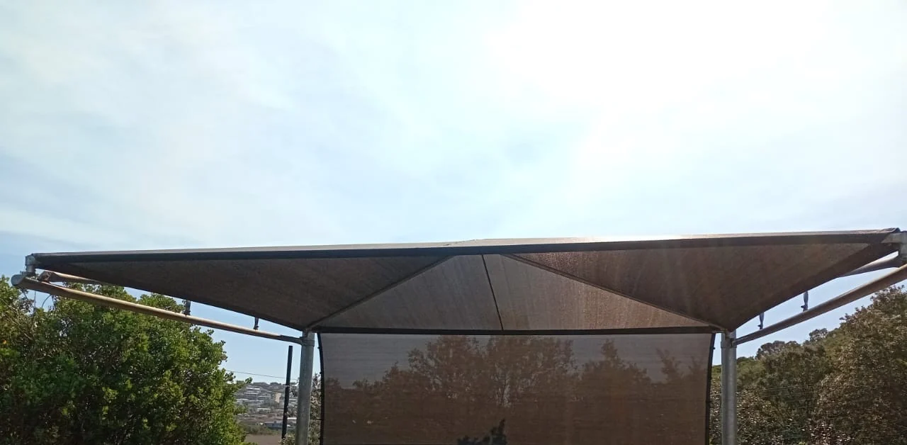 Shade net shadeport installed in Plettenberg Bay, Garden Route, galvanised steel frame with UV shade cloth and drop-down side panel by Custom Blinds Shutters & Awnings, Garden Route, South Africa