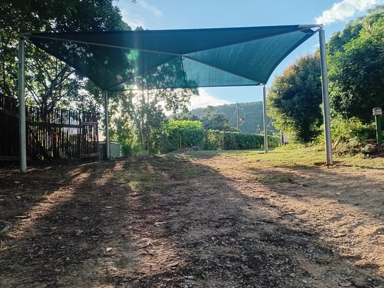 Shade net shadeport installation Wilderness Garden Route, galvanised steel frame, afternoon light through indigenous trees by Custom Blinds Shutters & Awnings, Garden Route, South Africa