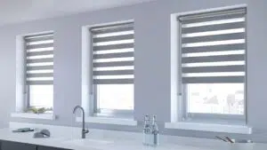 Custom Blinds Shutters & Awnings South Africa A bright kitchen with double roller zebra blinds on three windows; these stylish blinds add privacy and a clean, modern feel. Garden Route & Online