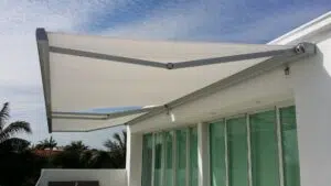 Retractable folding arm awning