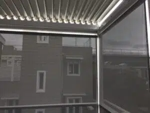 Custom Blinds South Africa Relax behind a screened balcony with slatted roofing, enjoying privacy and shade whilst taking in city views on a cloudy Thesen Island Knysna day. Garden Route & Online