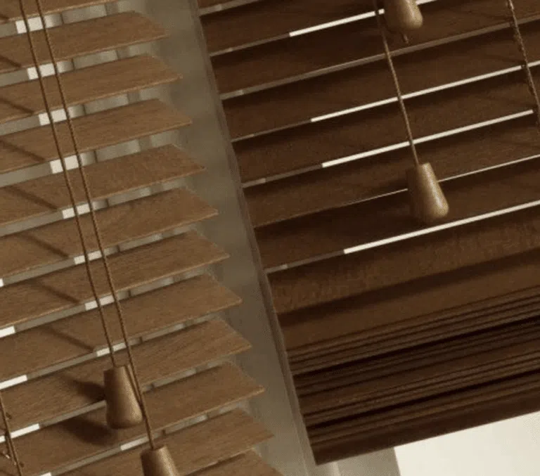 Close-up of wooden venetian blind slats showing natural wood grain texture and quality finish
