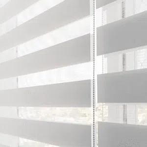 Custom Blinds Shutters & Awnings South Africa white double roller zebra blinds in the lounge gently filter light and add privacy, creating a welcoming space for any UK home. Garden Route & Online