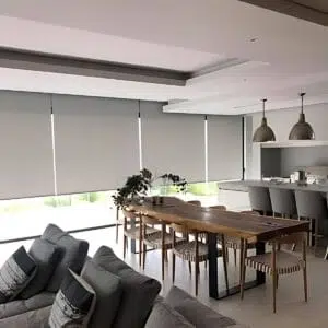 Custom Blinds Shutters & Awnings South Africa A bright, open-plan Plettenberg Bay area with sheer roller blinds for privacy, adding style and natural light to this inviting family home. Garden Route & Online