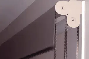 Duo roller blind showing twin beaded chain controls on a window frame for independent operation of sheer and blockout fabrics