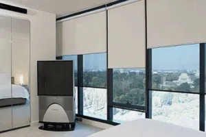 Stylish bedroom with floor to ceiling windows and duo roller blinds providing privacy and filtered light