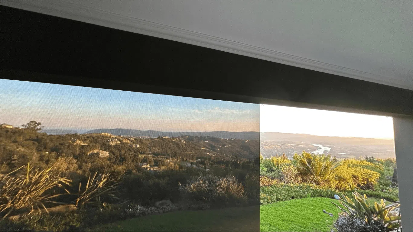 Outdoor drop-down blinds providing shade and privacy on patio