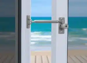 Open door revealing seaside view.