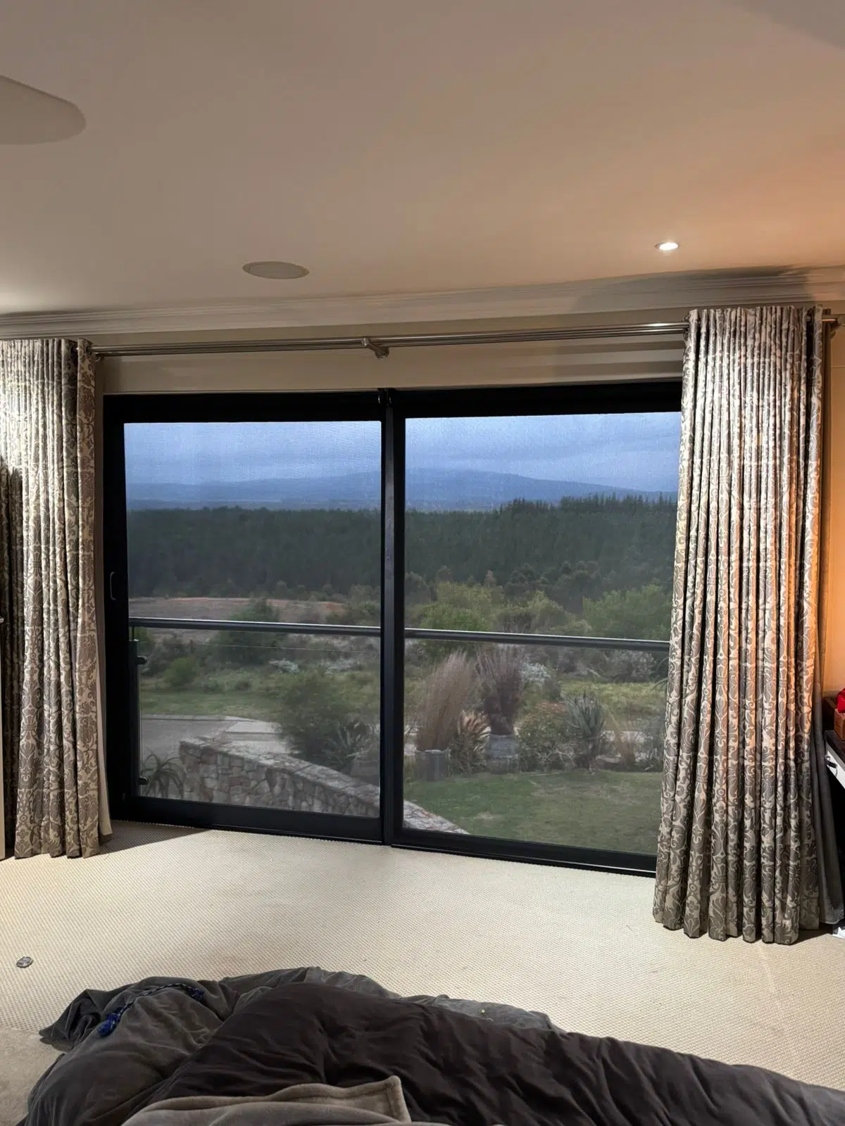 Sheer charcoal roller blinds installed at Simola Estate Knysna with mountain views