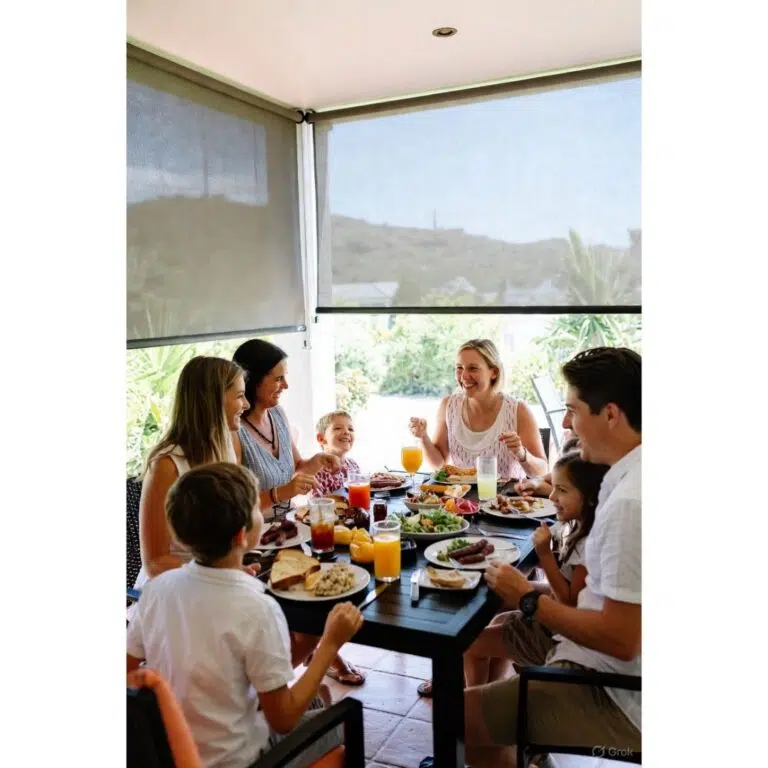 Family dining behind outdoor blinds on a Garden Route patio