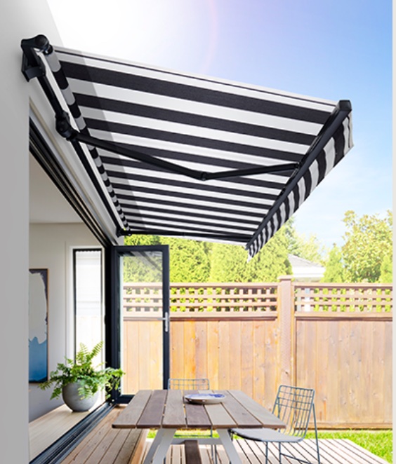 Striped retractable folding arm canvas awning on a Garden Route patio by Custom Blinds