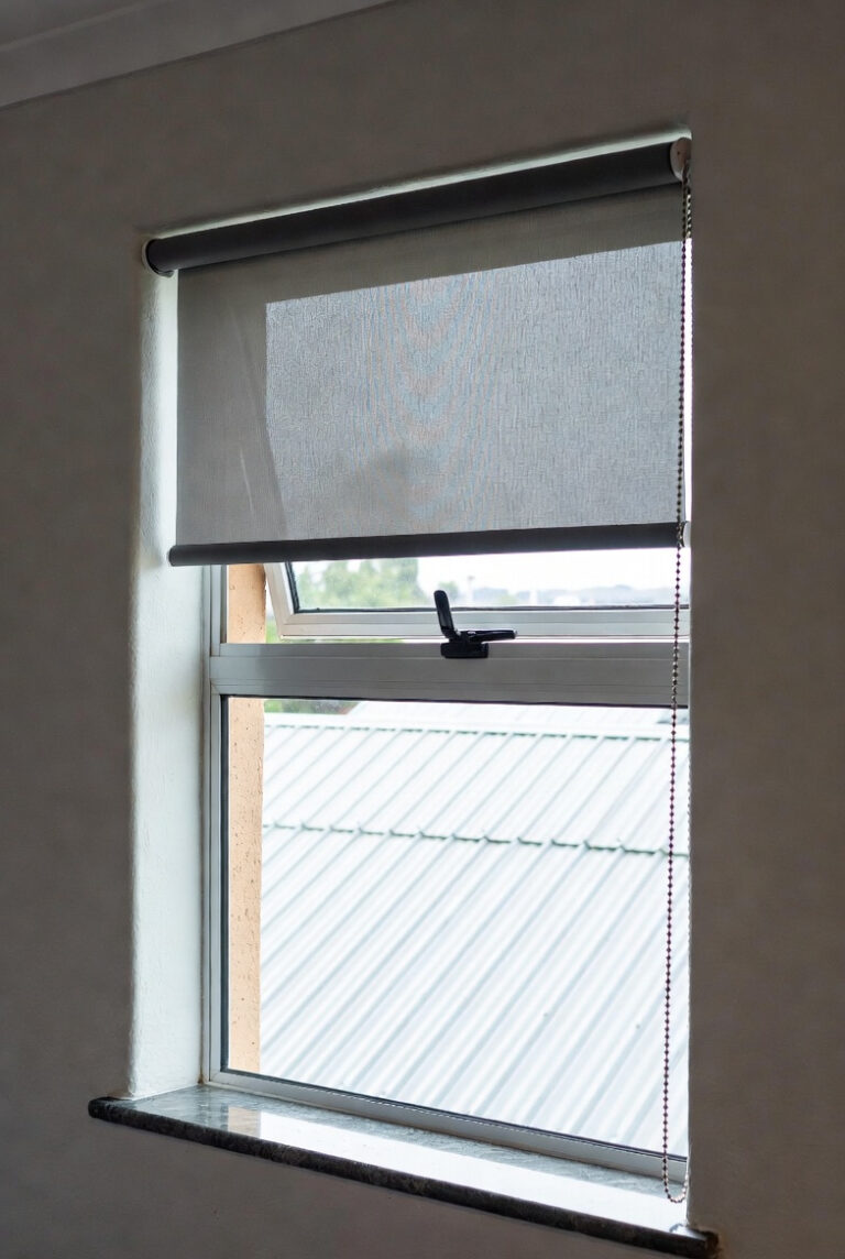No-drill roller blind with dark sheerweave fabric on aluminium window. Custom Blinds tension-mount system delivered online across South Africa