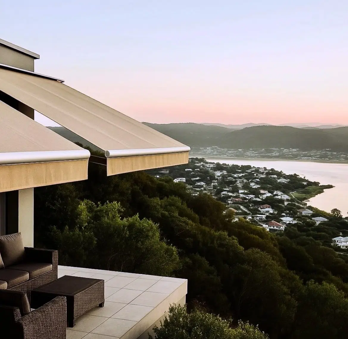 Retractable folding arm awning on a Knysna home with lagoon and Heads views at sunset