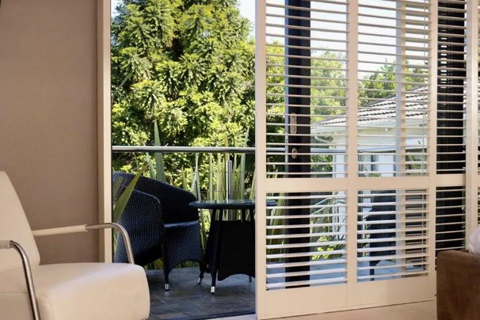 PVC indoor shutters on sliding balcony door at Cambalala Guesthouse Knysna opening onto garden