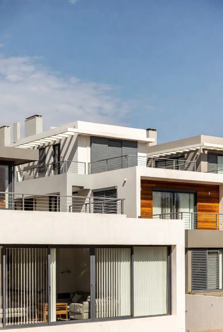 Modern South African home with vertical blinds on full-height sliding doors, contemporary architecture