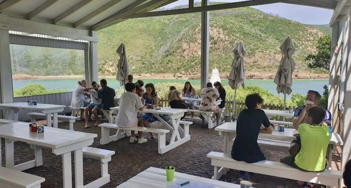 Clear PVC blinds at East Head Cafe Knysna with diners and full view of the Knysna Heads through transparent panels