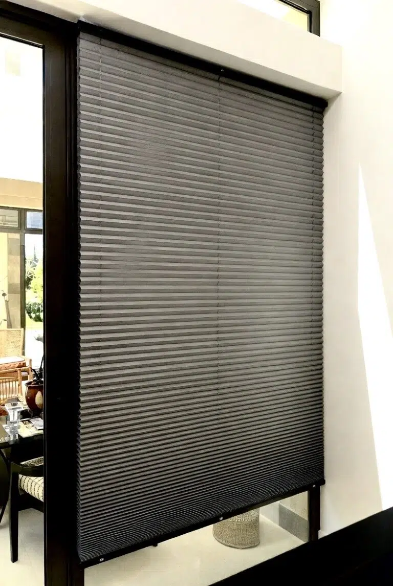 Grey duotone honeycomb blinds installed on a sliding door in a South African home