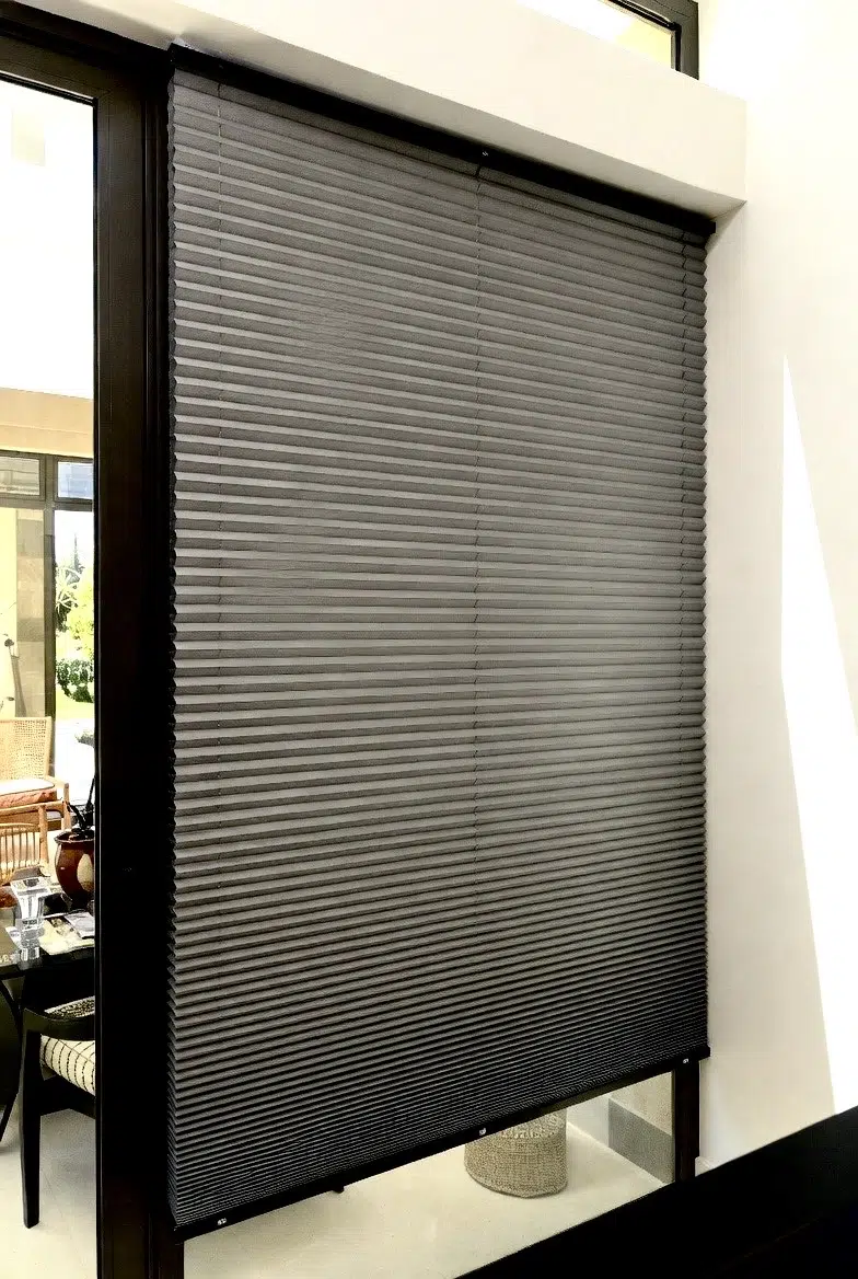 Honeycomb blinds in grey duotone installed in a South African home, showing cellular structure and clean lines