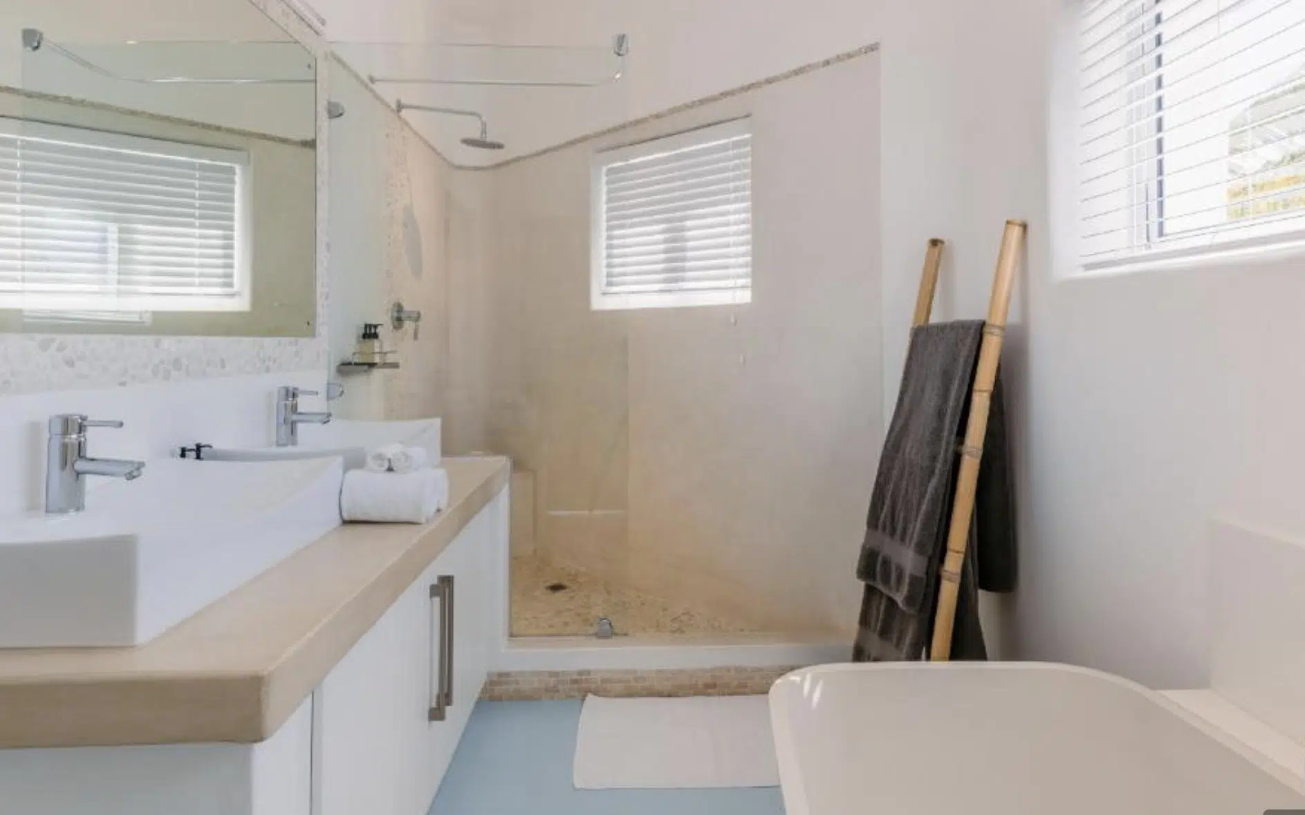 Plaswood venetian blinds in a coastal bathroom with white fittings and natural light, Santorini Lodge Mozambique