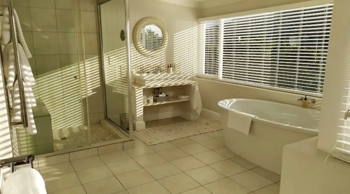 Plaswood venetian blinds in guest bathroom at Leisure Isle Lodge Knysna with freestanding bath