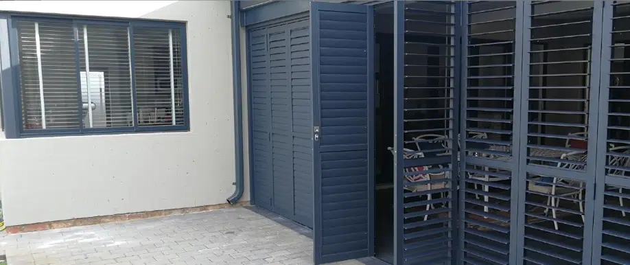 Charcoal aluminium security shutters bifold exterior installation with louvred panels
