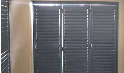 Charcoal aluminium security shutters with adjustable louvres, indoor view