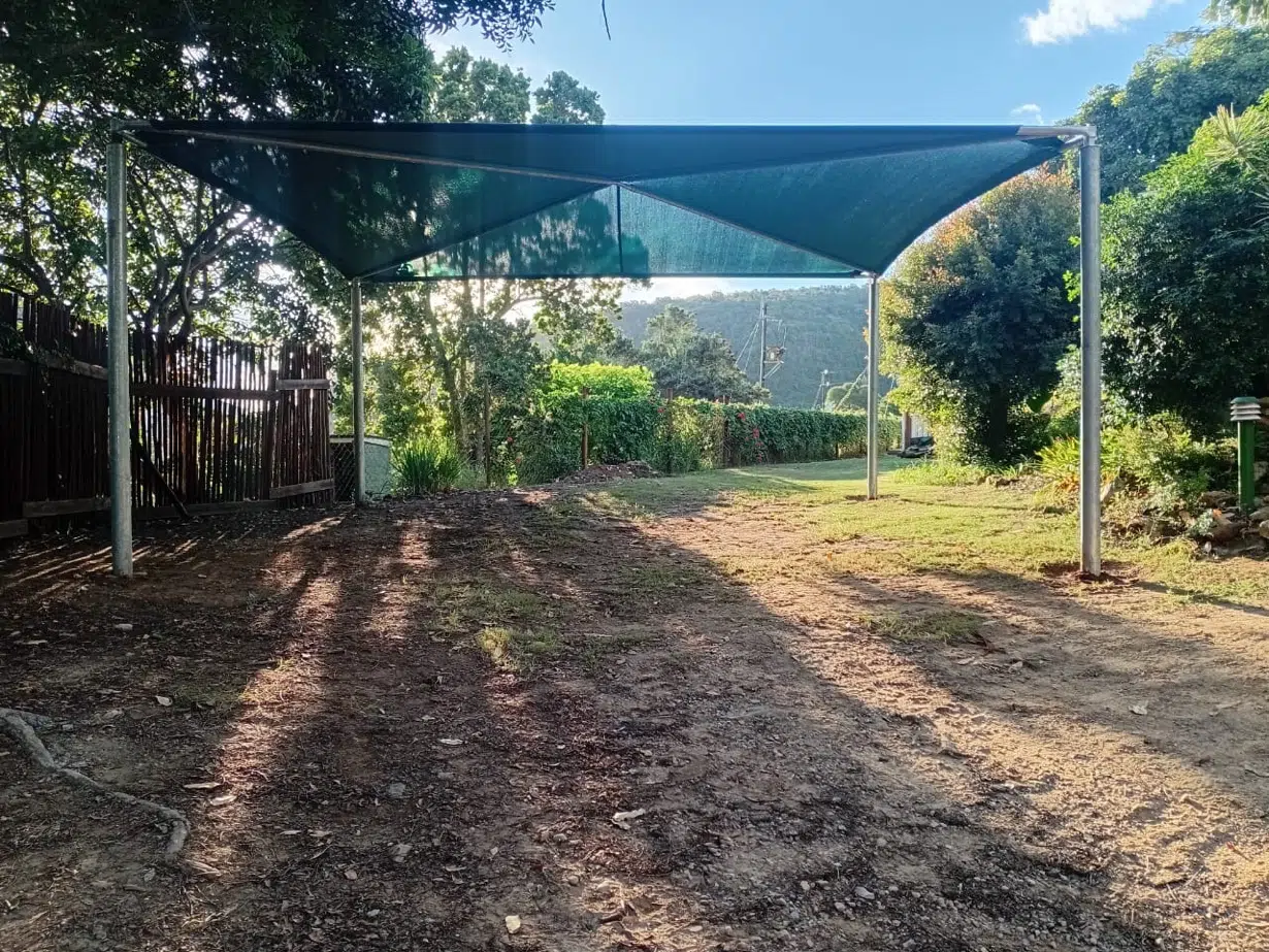 Shade net shadeport installation in Wilderness, Garden Route. Galvanised steel frame with green shade cloth. Custom Blinds installation.