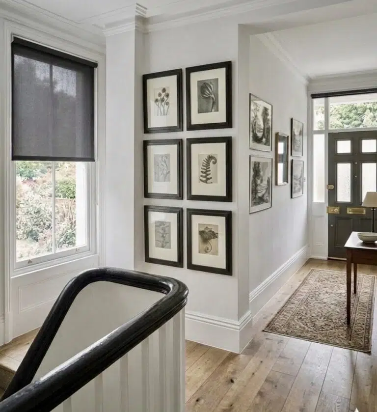 Charcoal sheer roller blind in a colonial hallway preserving garden views while reducing UV glare