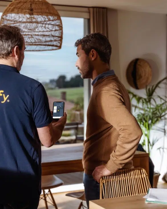 Somfy expert demonstrating motorised blind app control during home consultation