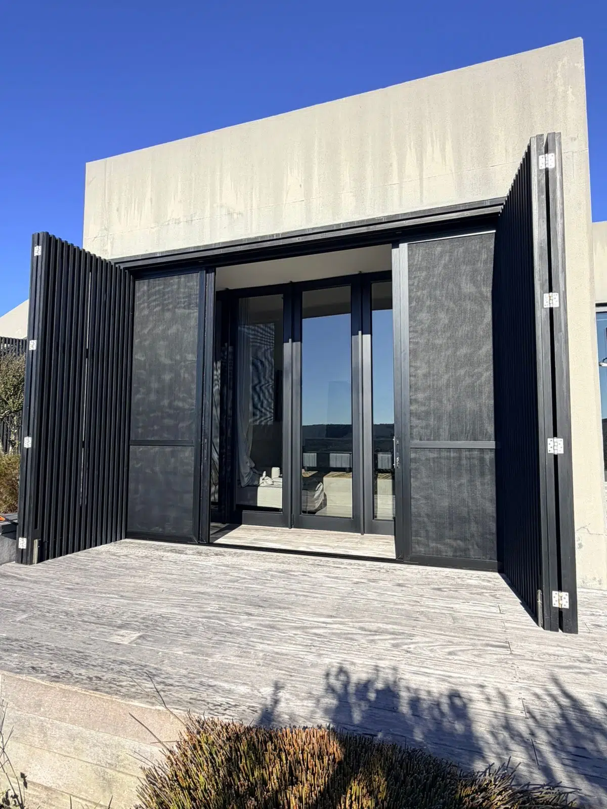 Corner Star security and insect screens stacked fully open at a Pezula Private Estate home, Knysna — Custom Blinds installation