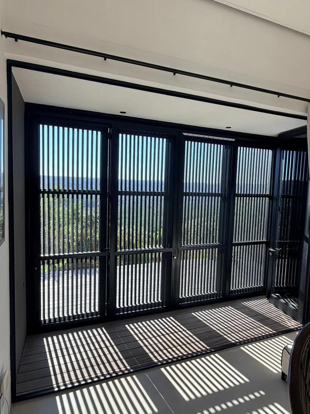 Full-width Corner Star security and insect screens closed across a living space, Custom Blinds expert installation in Pezula Private Estate, Knysna