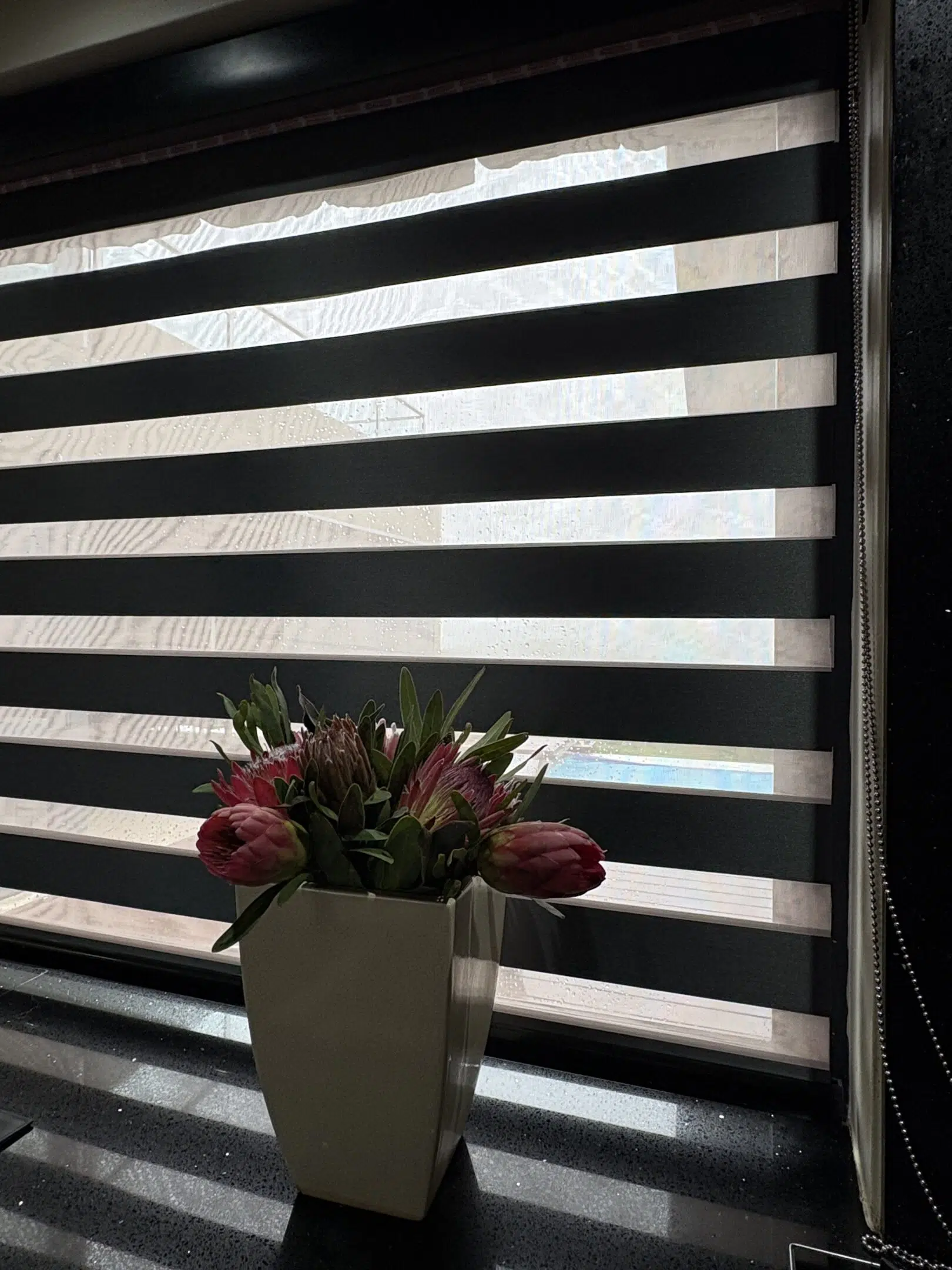 Double roller zebra blind in graphite, installed by Custom Blinds at a Keurbooms holiday home in Plettenberg Bay