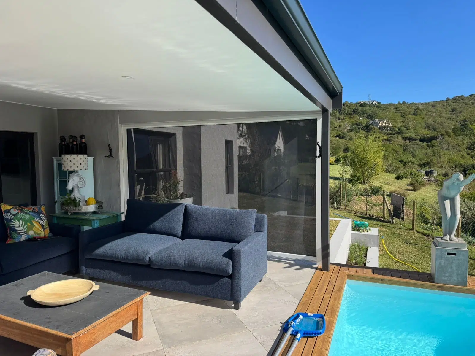 Outdoor blinds Knysna pool patio with mountain backdrop by Custom Blinds®