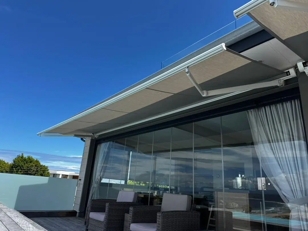 Retractable folding arm awning with clear PVC outdoor blinds installed in Plettenberg Bay by Custom Blinds