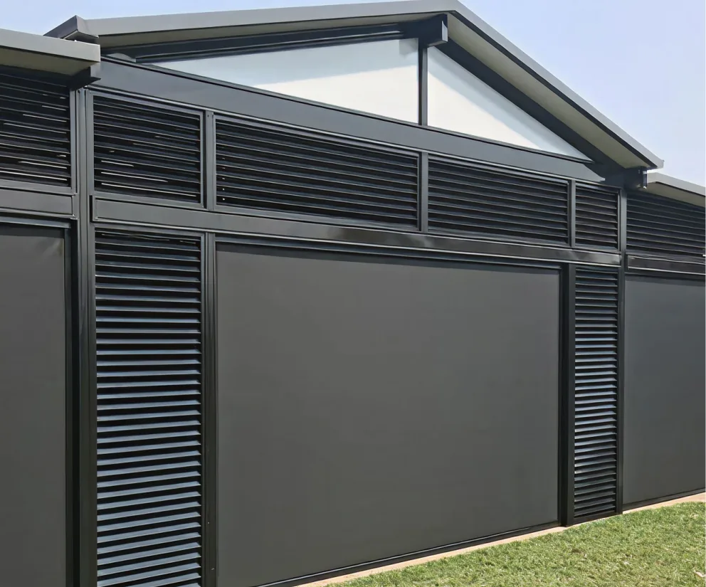 Charcoal Ziptrak® outdoor blinds lowered between black aluminium louvre panels on a gabled pavilion, from Custom Blinds Shutters & Awnings, authorised Ziptrak® agent, Garden Route, South Africa. Image credit Ziptrak®
